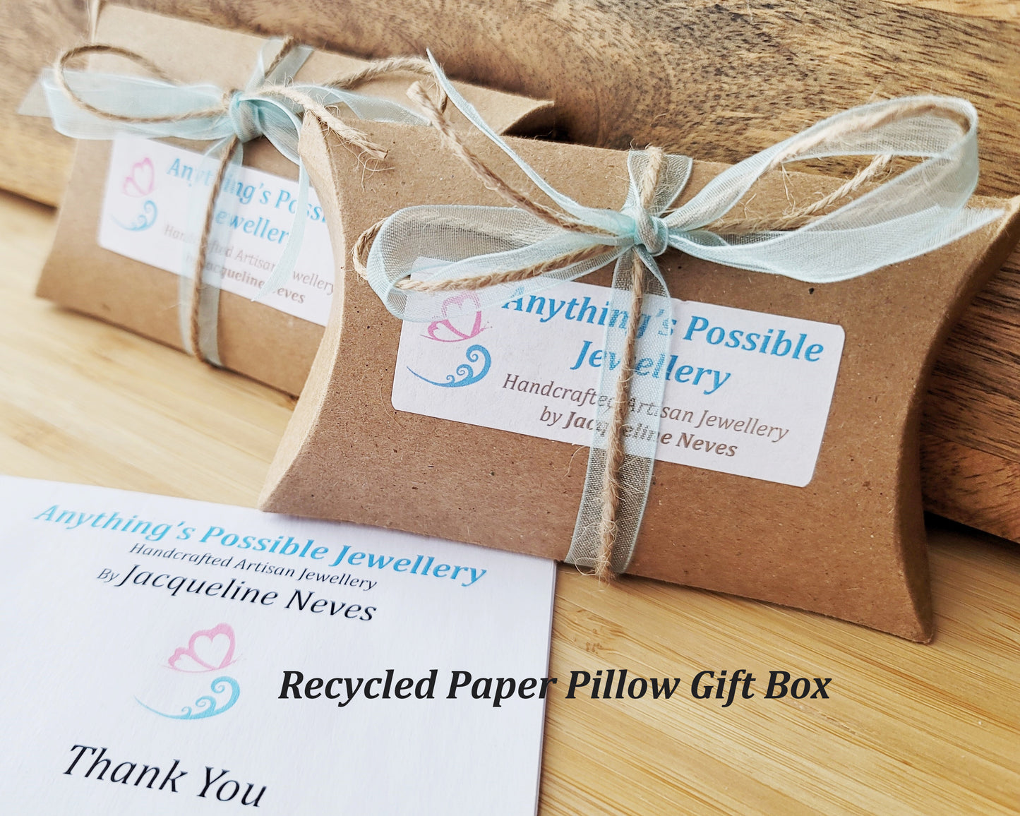 Kraft Paper Pillow Box's with Anything's Possible Jewellery labels, tied with pale blue ribbon and twine with wood background