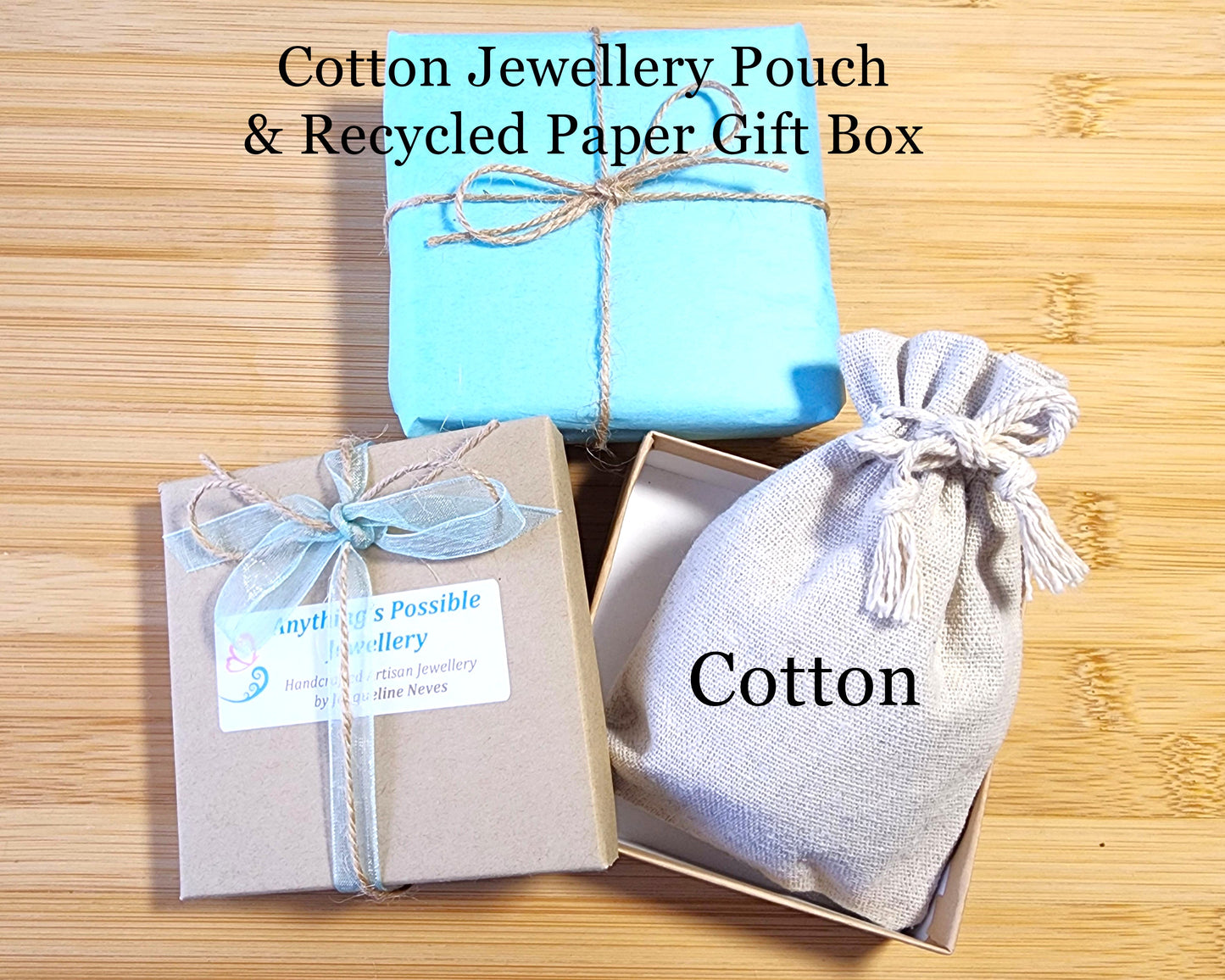 Recycled Kraft Paper Gift Box, Cotton Jewellery Pouch, Blue Tissue Paper tied with Blue Ribbon and Natural Twine-displayed on Wood back ground