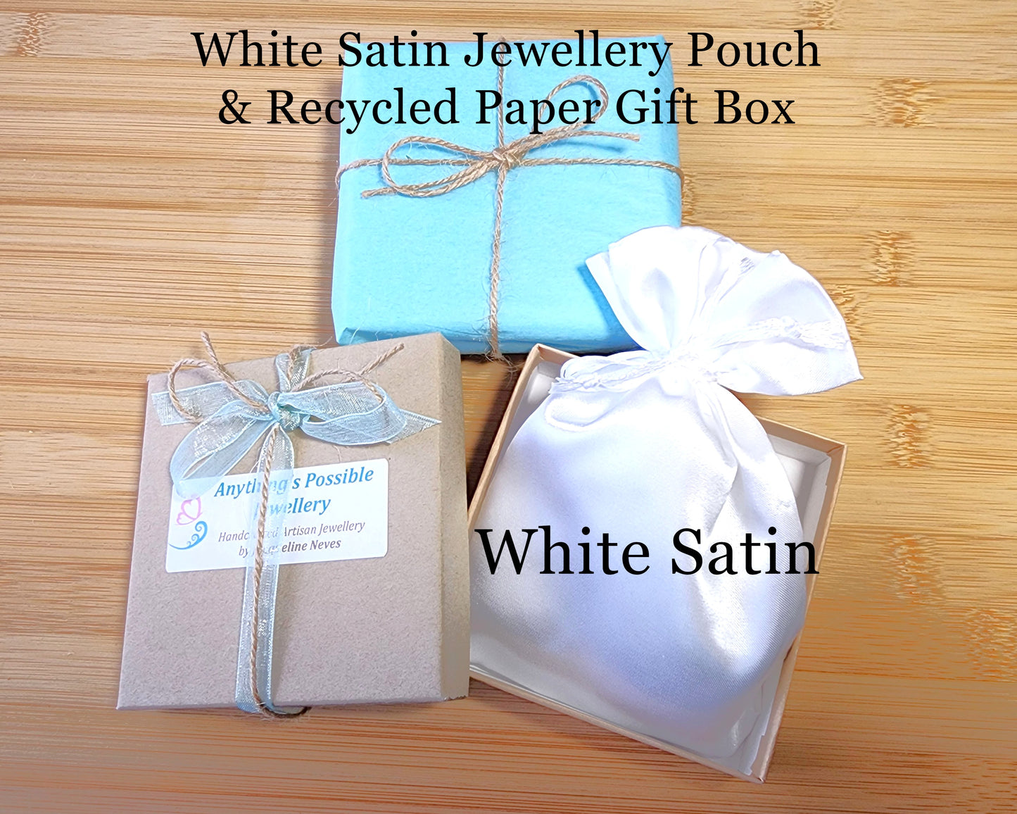 Recycled Kraft Paper Gift Box, White Satin Jewellery Pouch, Blue Tissue Paper tied with Blue Ribbon and Natural Twine-displayed on Wood back ground