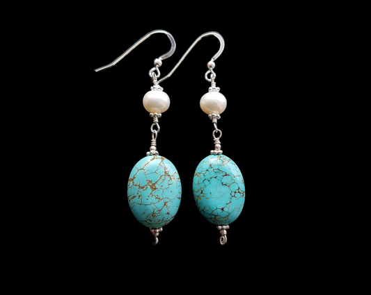 Long Art Deco Style Turquoise Pearl Dangle Earrings with Oval shaped Turquoise stone and round white pearls above, french style earring hooks on black background