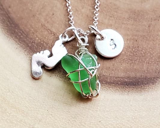 Personalized Footprints in the Sand Green Beach Glass Necklace, made with Sterling Silver, an Initial Pendant, Footprints pendant and a wire wrapped green Beach Glass pendant. 