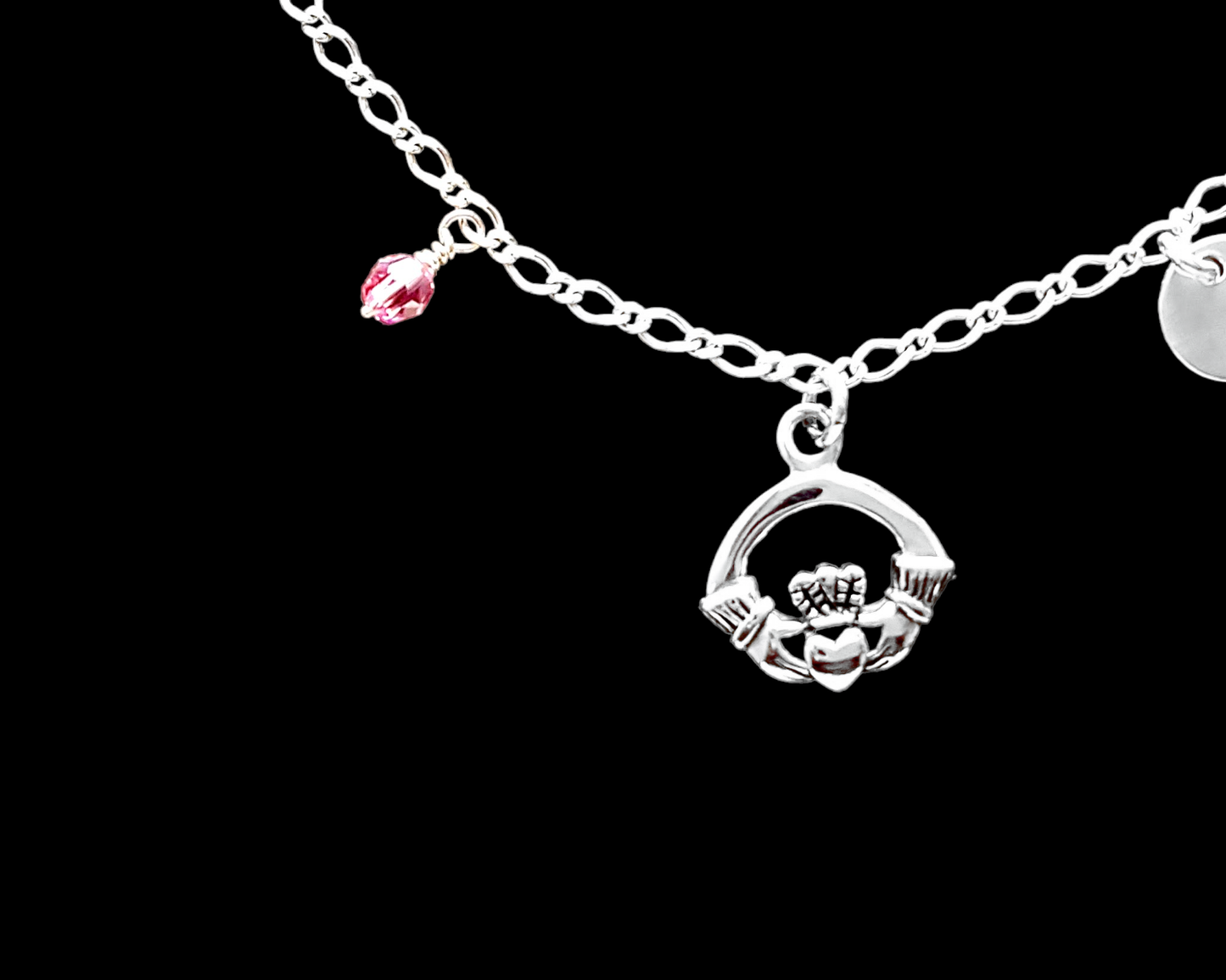Personalized Claddagh Ankle Bracelet-Anklet with Initial and Crystal Birthstone pendants dangling from a flat figaro chain.