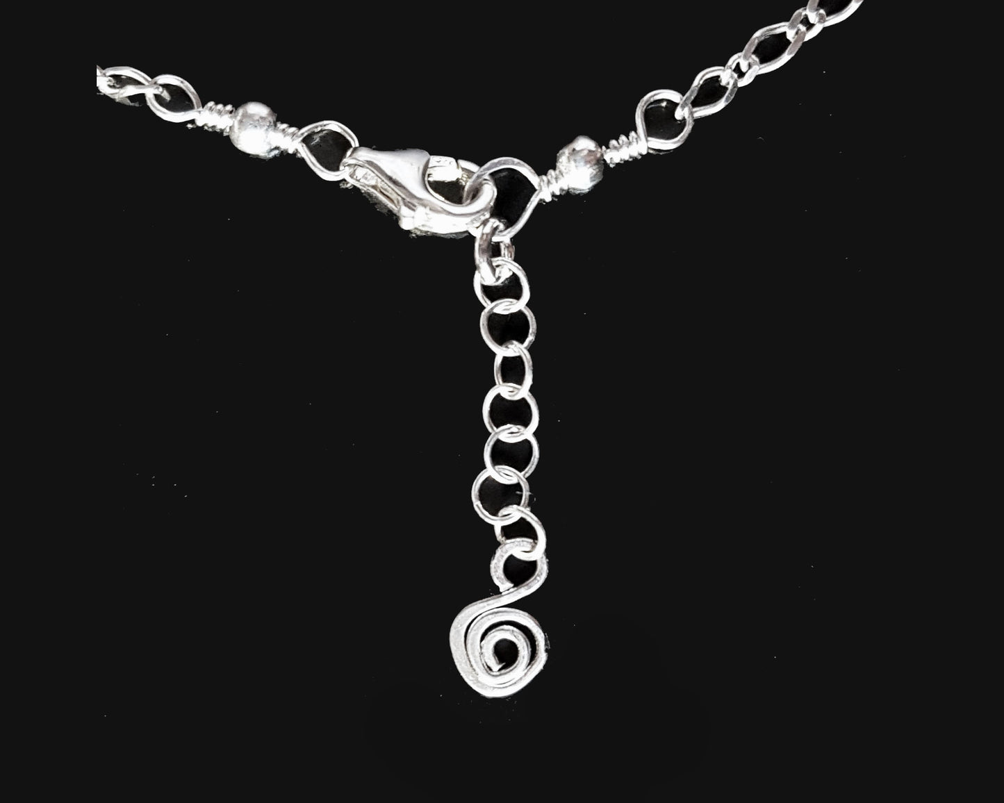 Anklet end with Extension chain and Celtic Eternity Coil dangling on the end. 