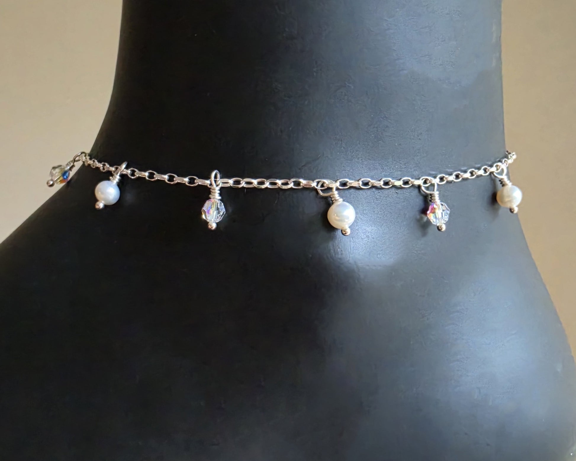 Silver Anklet Ankle Bracelet with small white Freshwater Cultured Pearls and Crystal Dangles from on chain displayed on black ankle