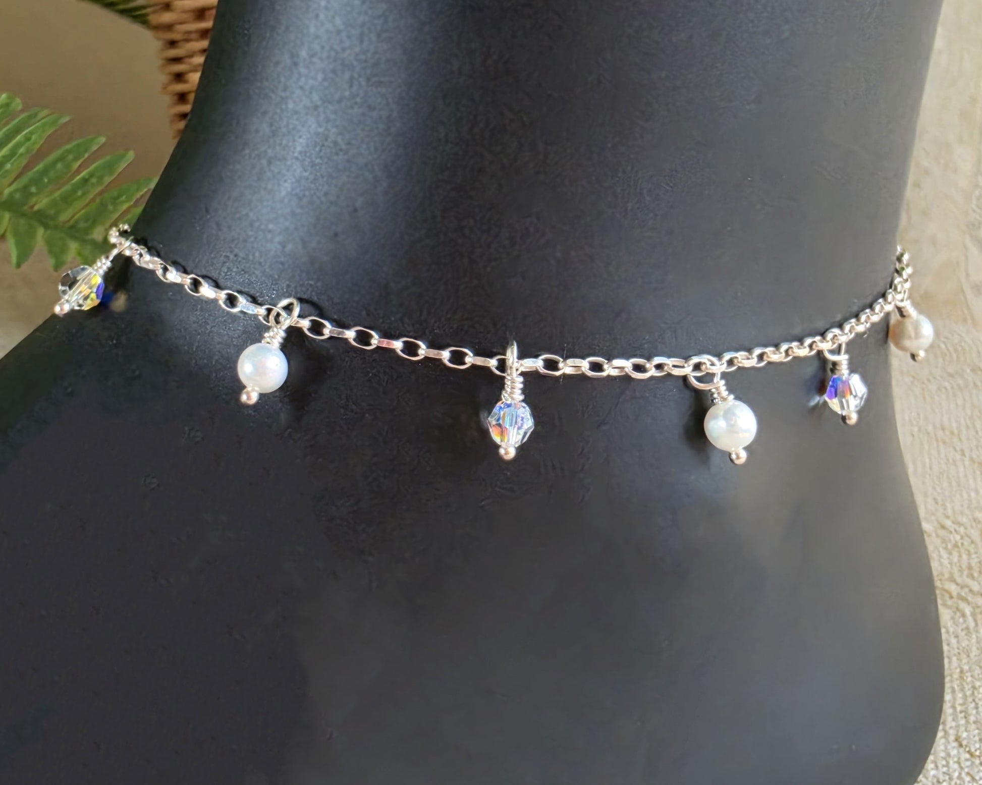 Silver Anklet Ankle Bracelet with small white Freshwater Cultured Pearls and Crystal Dangles from on chain displayed on black ankle