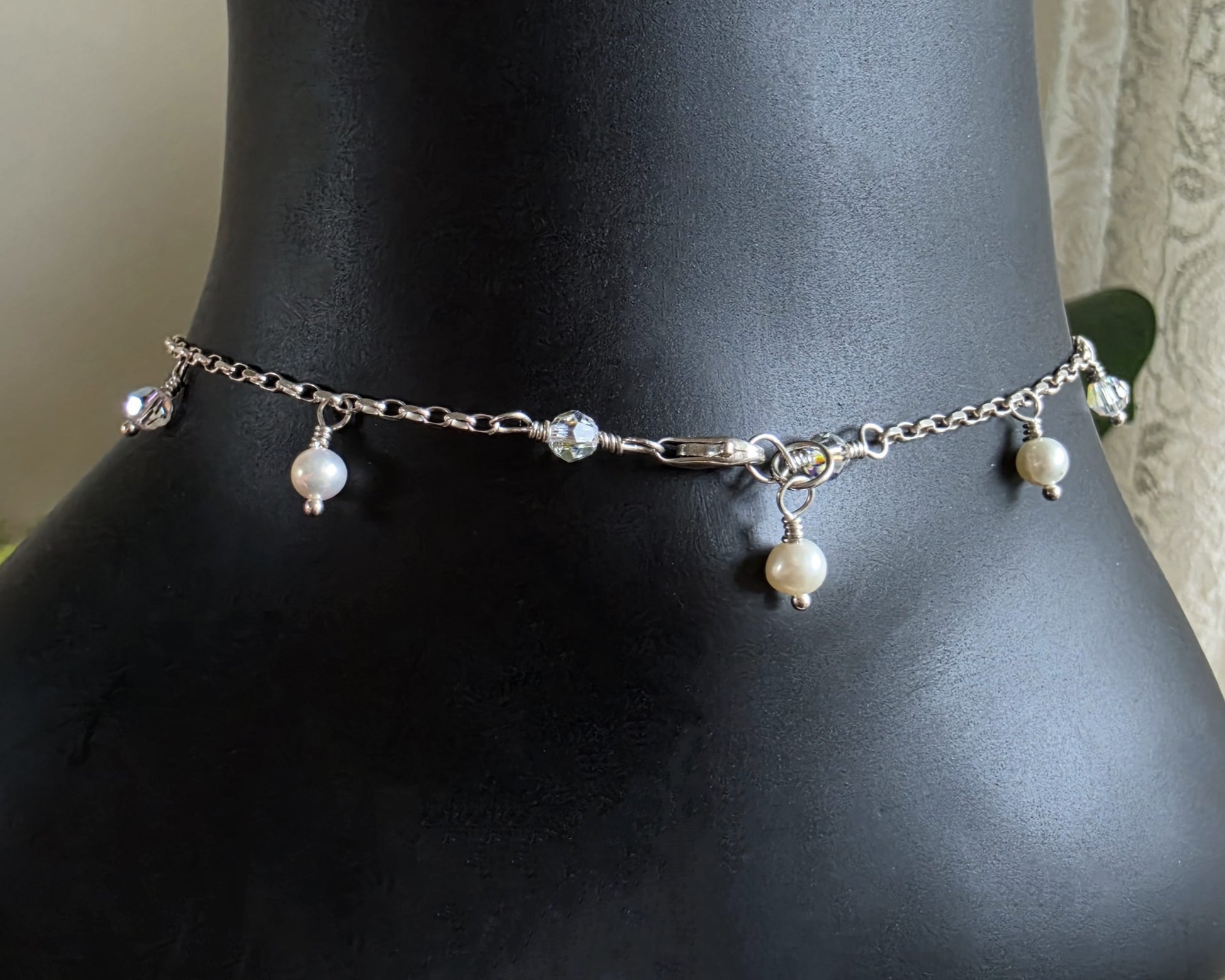 Silver Anklet Ankle Bracelet with small white Freshwater Cultured Pearls and Crystal Dangles from on chain displayed on black ankle