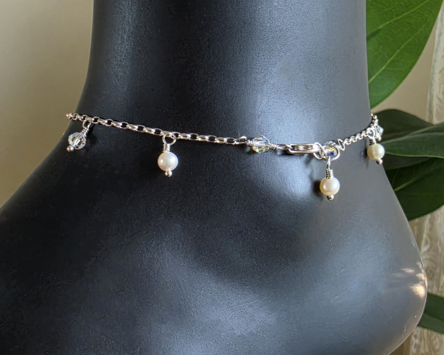 Silver Anklet Ankle Bracelet with small white Freshwater Cultured Pearls and Crystal Dangles from on chain displayed on black ankle