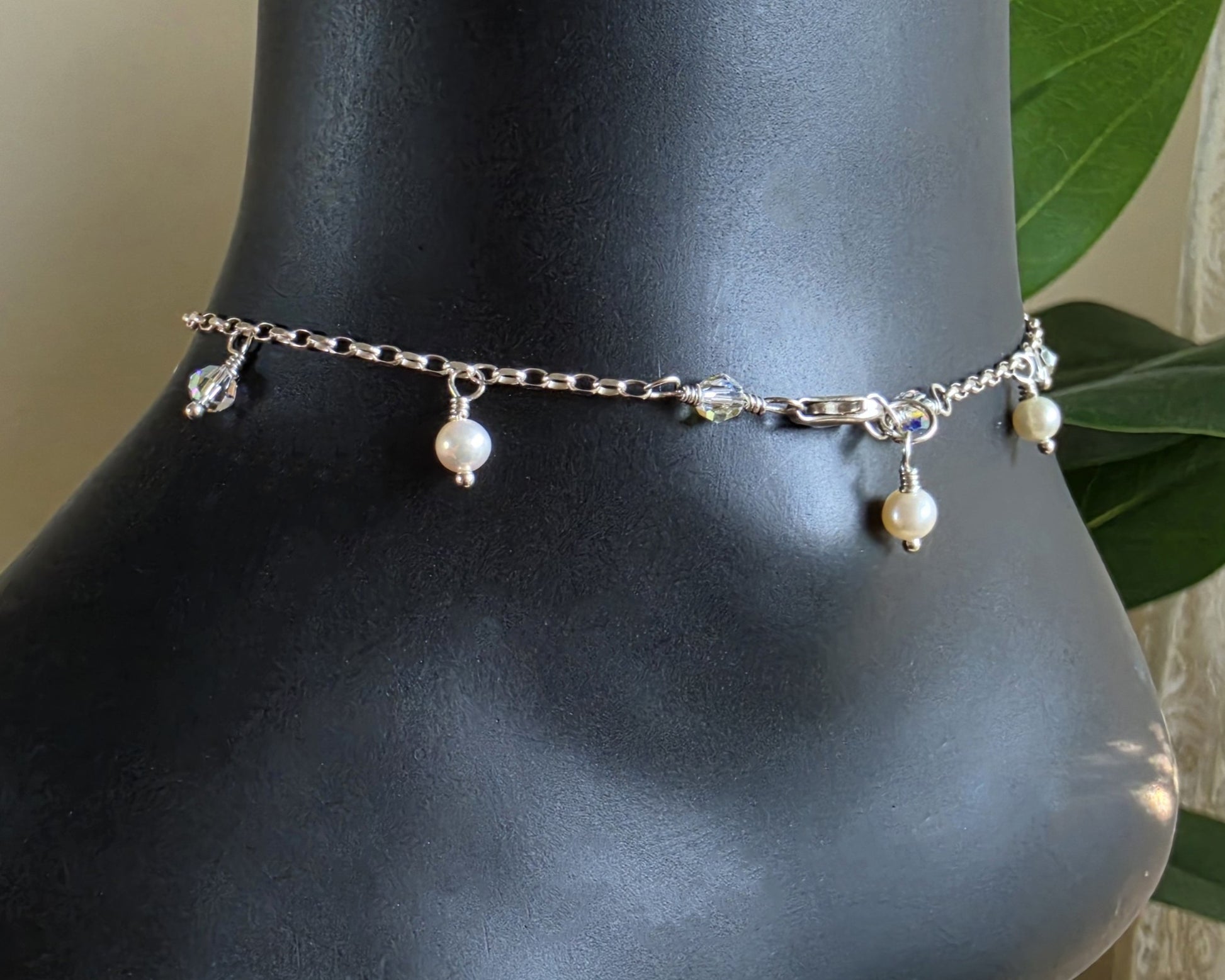 Silver Anklet Ankle Bracelet with small white Freshwater Cultured Pearls and Crystal Dangles from on chain displayed on black ankle