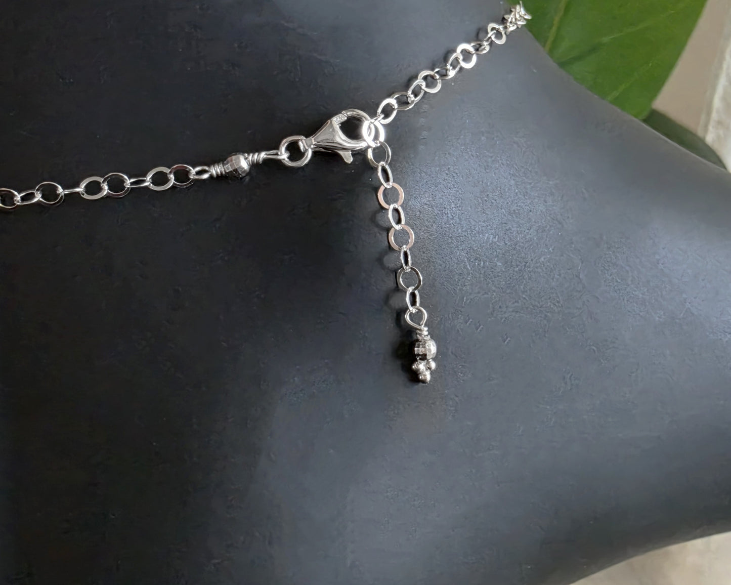 Silver Chain Anklet Ankle Bracelet with a lobster claw clasp on black foot