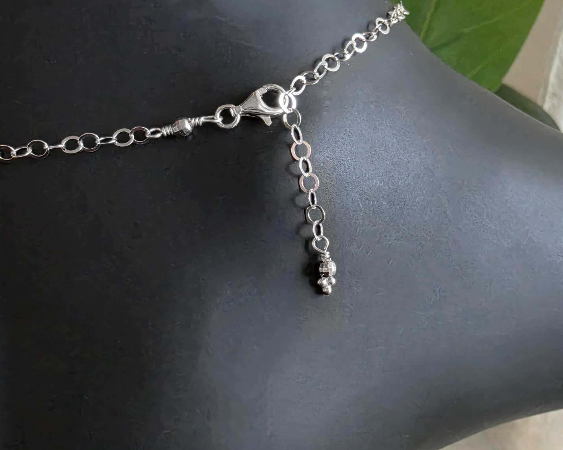 Silver Chain Anklet Ankle Bracelet with a lobster claw clasp on black foot