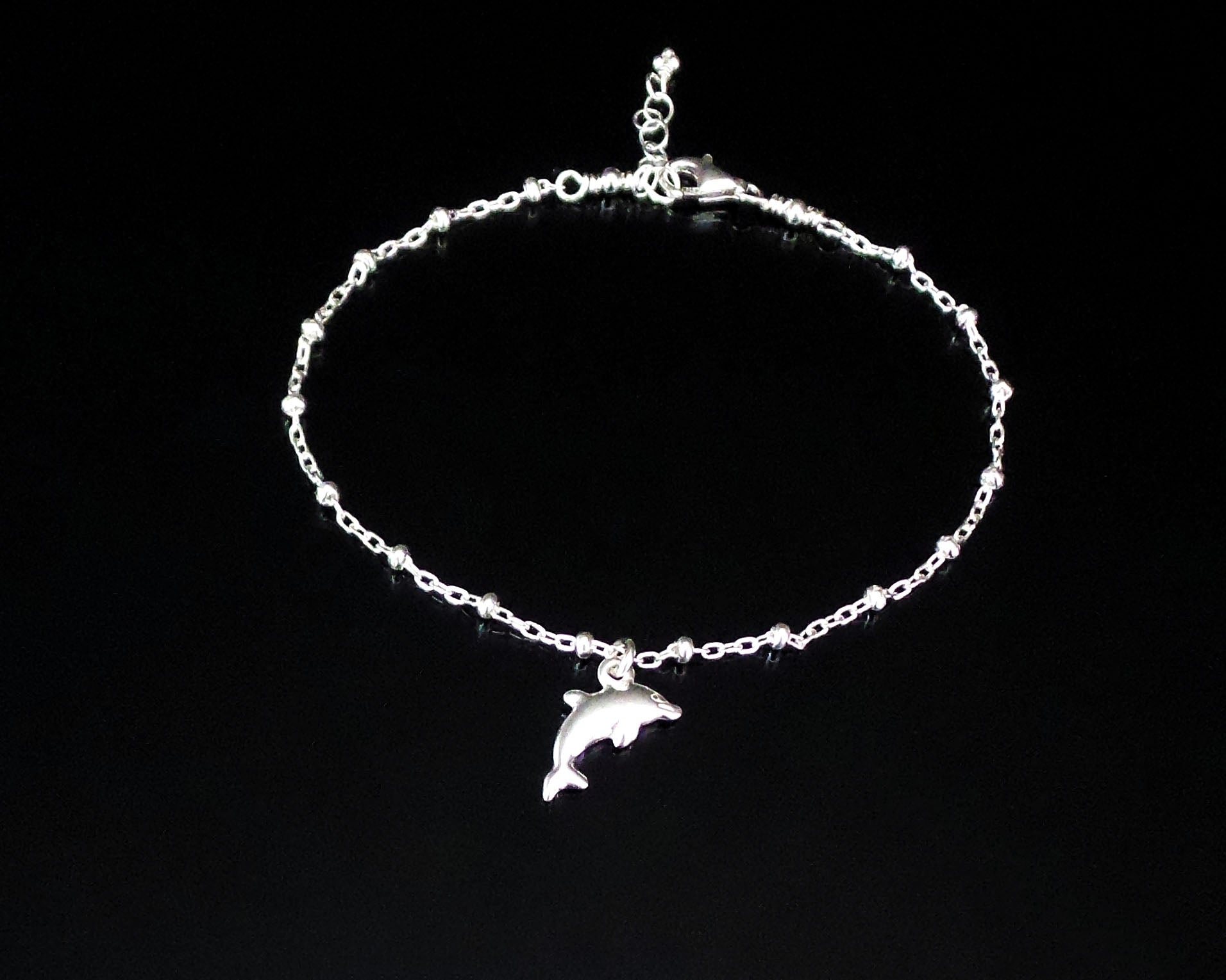 Silver Dolphin Anklet, Ankle Bracelet with Dolphin Pendant on Satellite Chain, Lobster Claw Clasp and Extension chain on black background 
