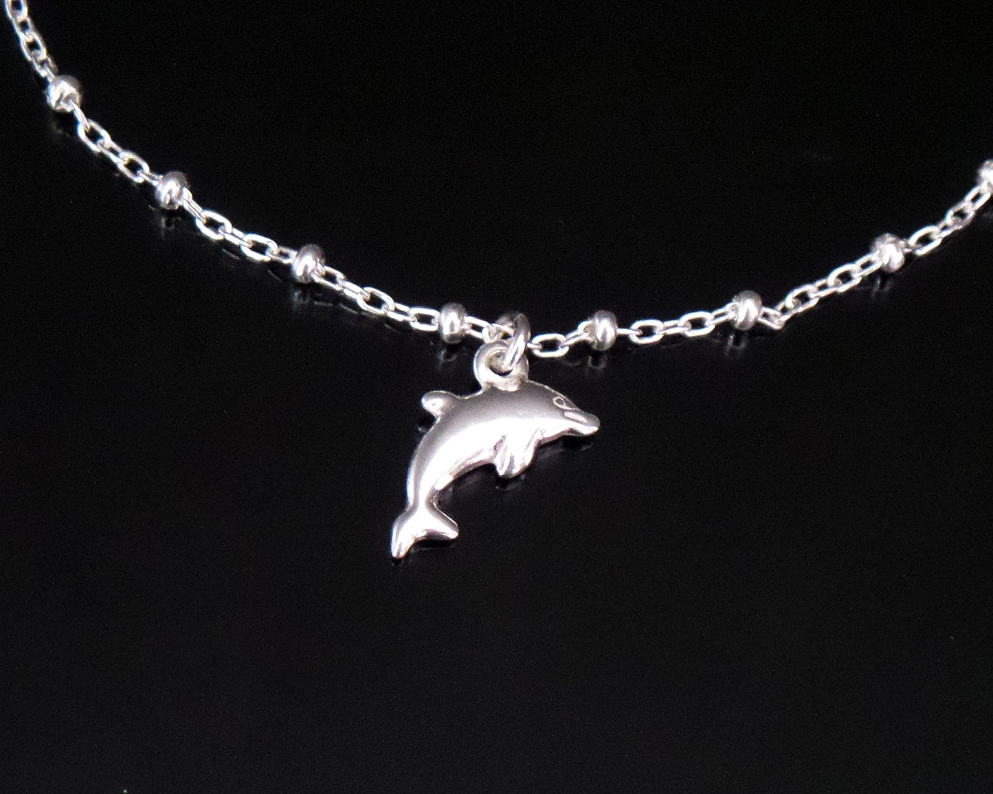Dolphin Pendant on Satellite Chain on black background