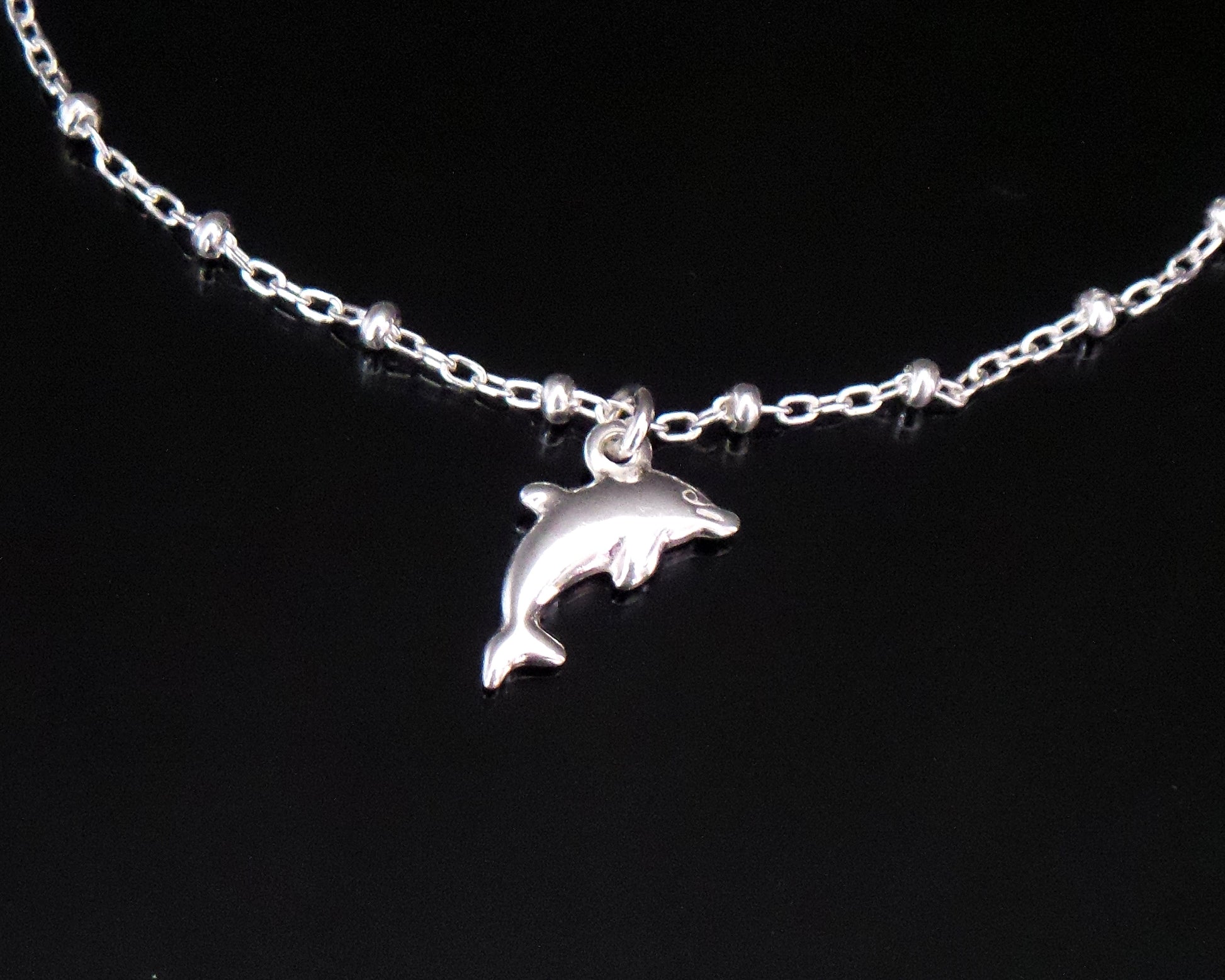 Dolphin Pendant on Satellite Chain on black background