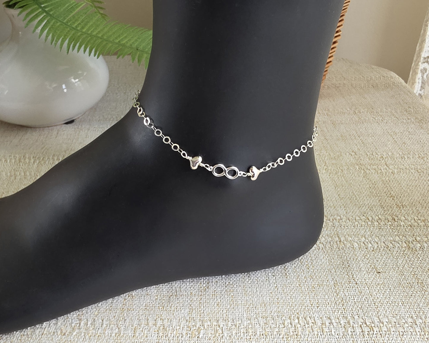 Silver Anklet with infinity pendant and two hearts on either side on chain 