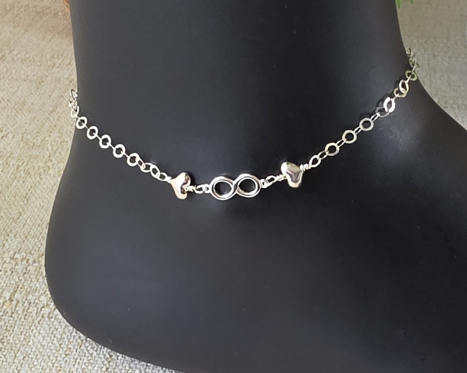 Silver Anklet with infinity pendant and two hearts on either side on chain 