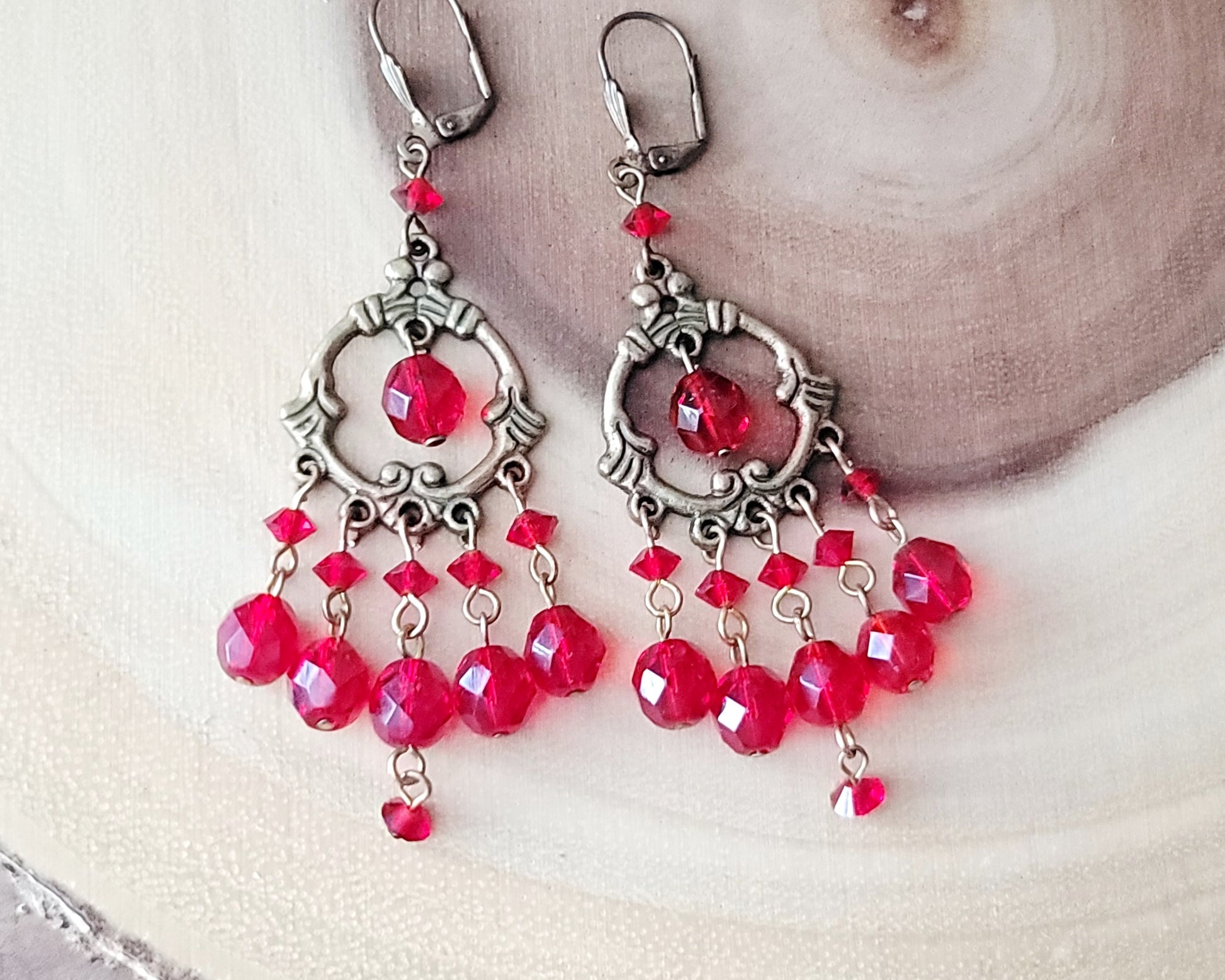Long Ruby Red Crystal Chandelier Earrings on wood