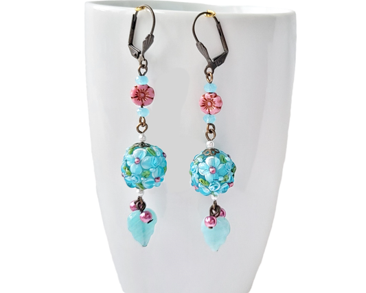 Long Aqua Pink Floral Dangle Earrings displayed on white