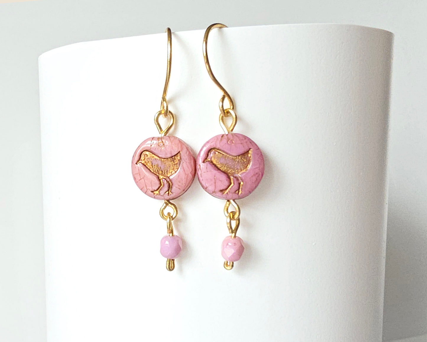 Rose Pink Gold Dangle Earrings with Sparrow Bird on white stand 