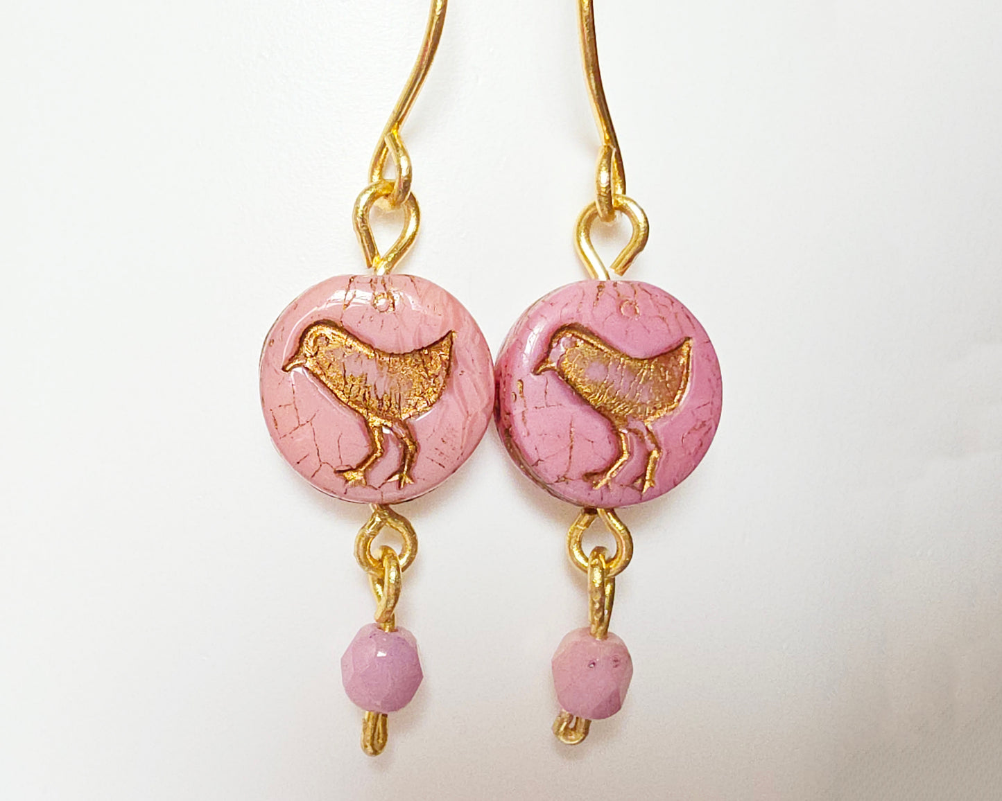 Rose Pink Gold Dangle Earrings with Sparrow Bird on white  background 