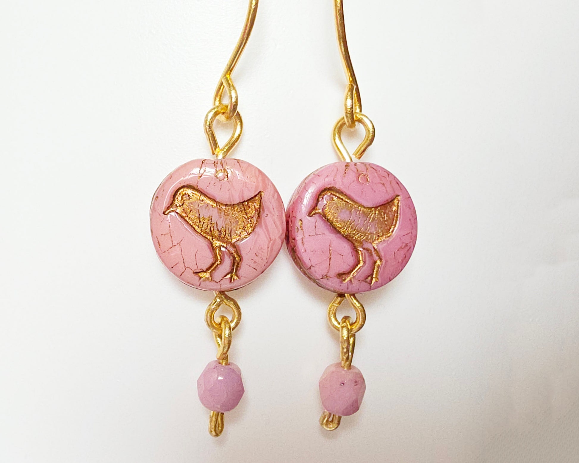 Rose Pink Gold Dangle Earrings with Sparrow Bird on white  background 