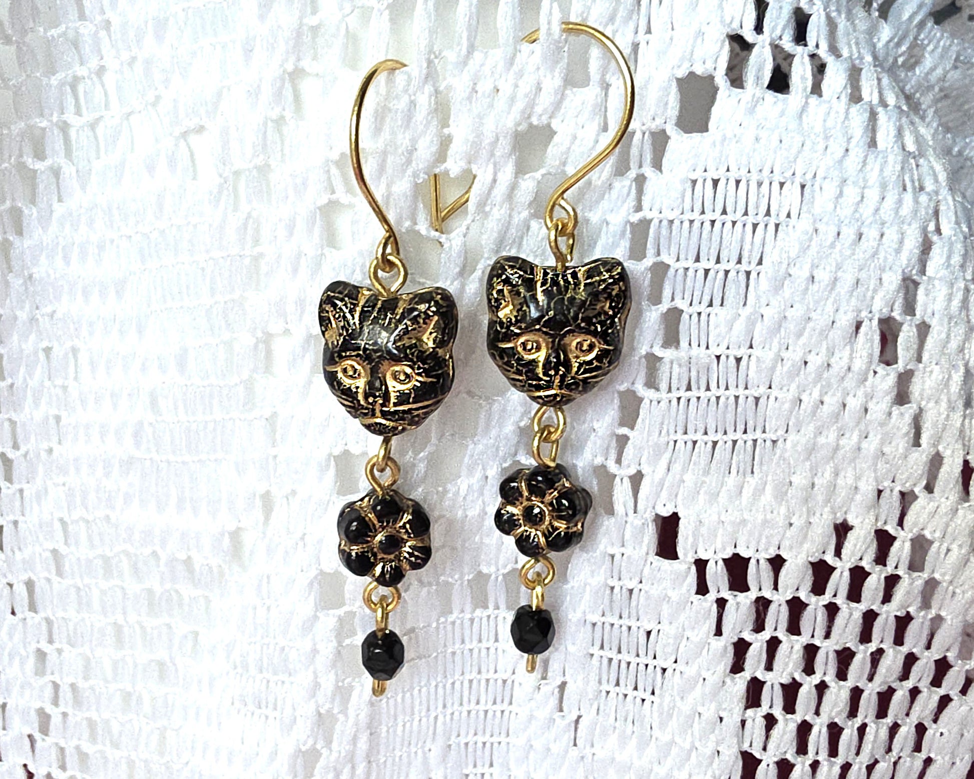 Long Beaded Black Cat Earrings with Gold detail and Brass french hooks on lace background 