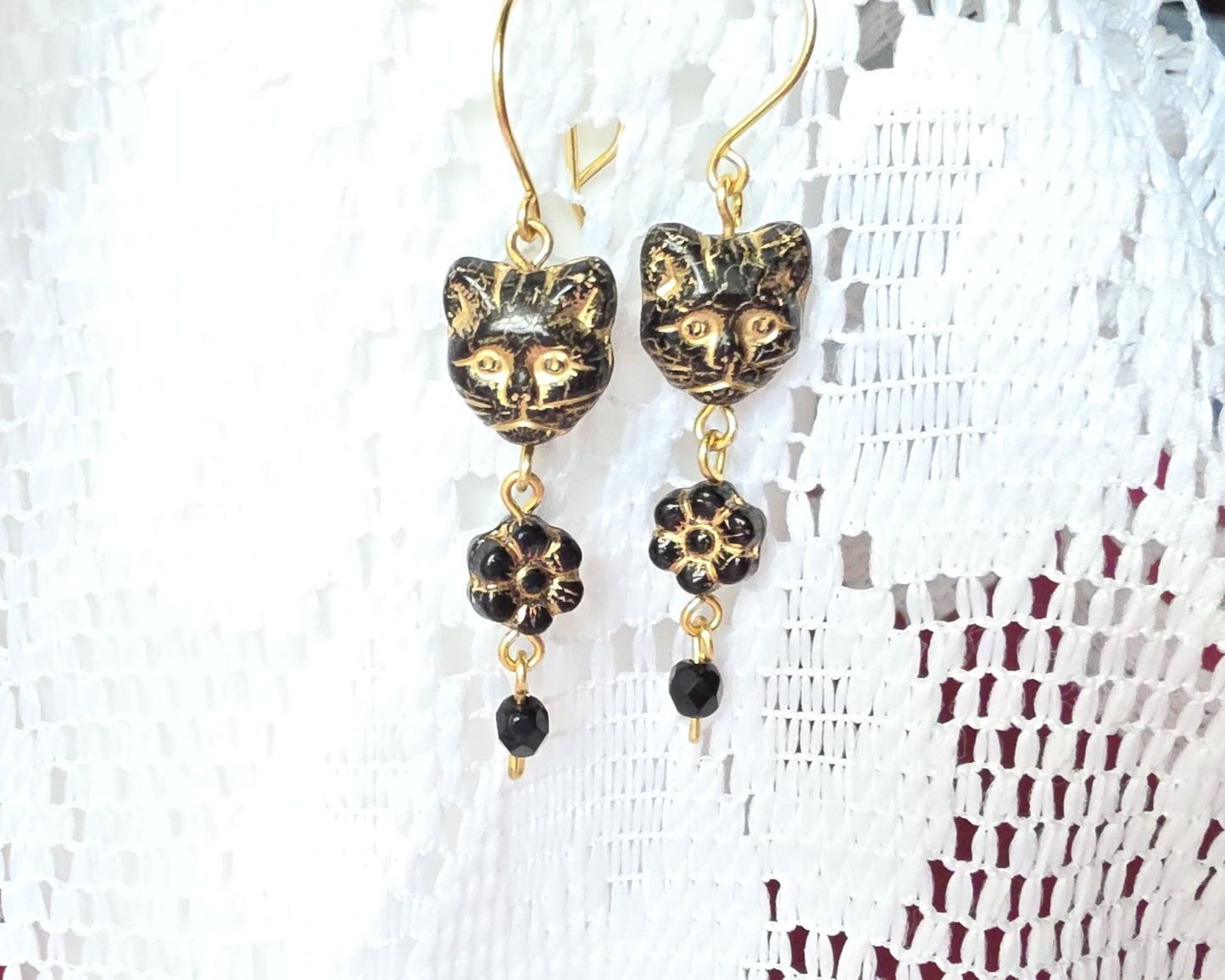 Long Beaded Black Cat Earrings with Gold detail and Brass french hooks on lace background 