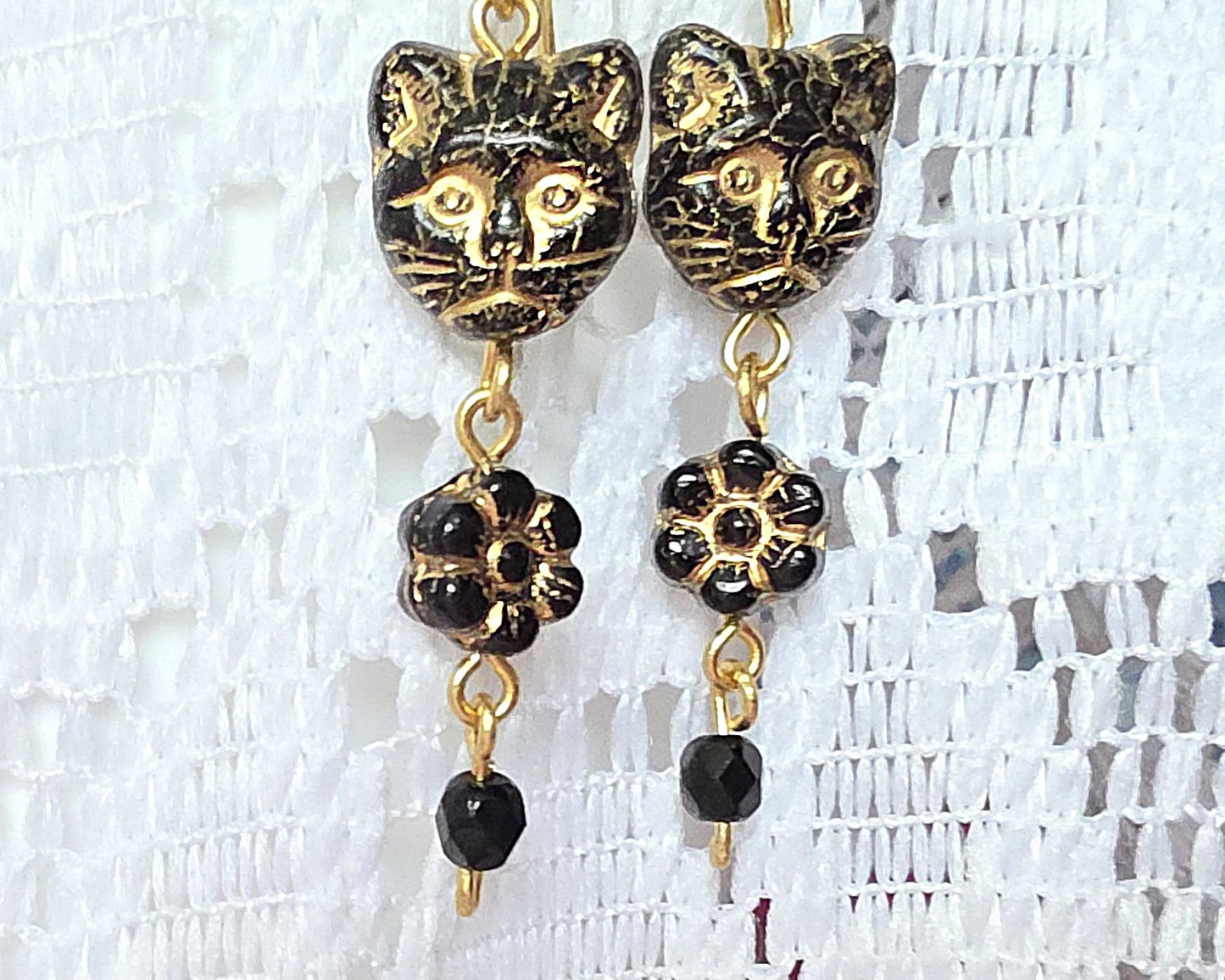Long Beaded Black Cat Earrings with Gold detail and Brass french hooks on lace background 