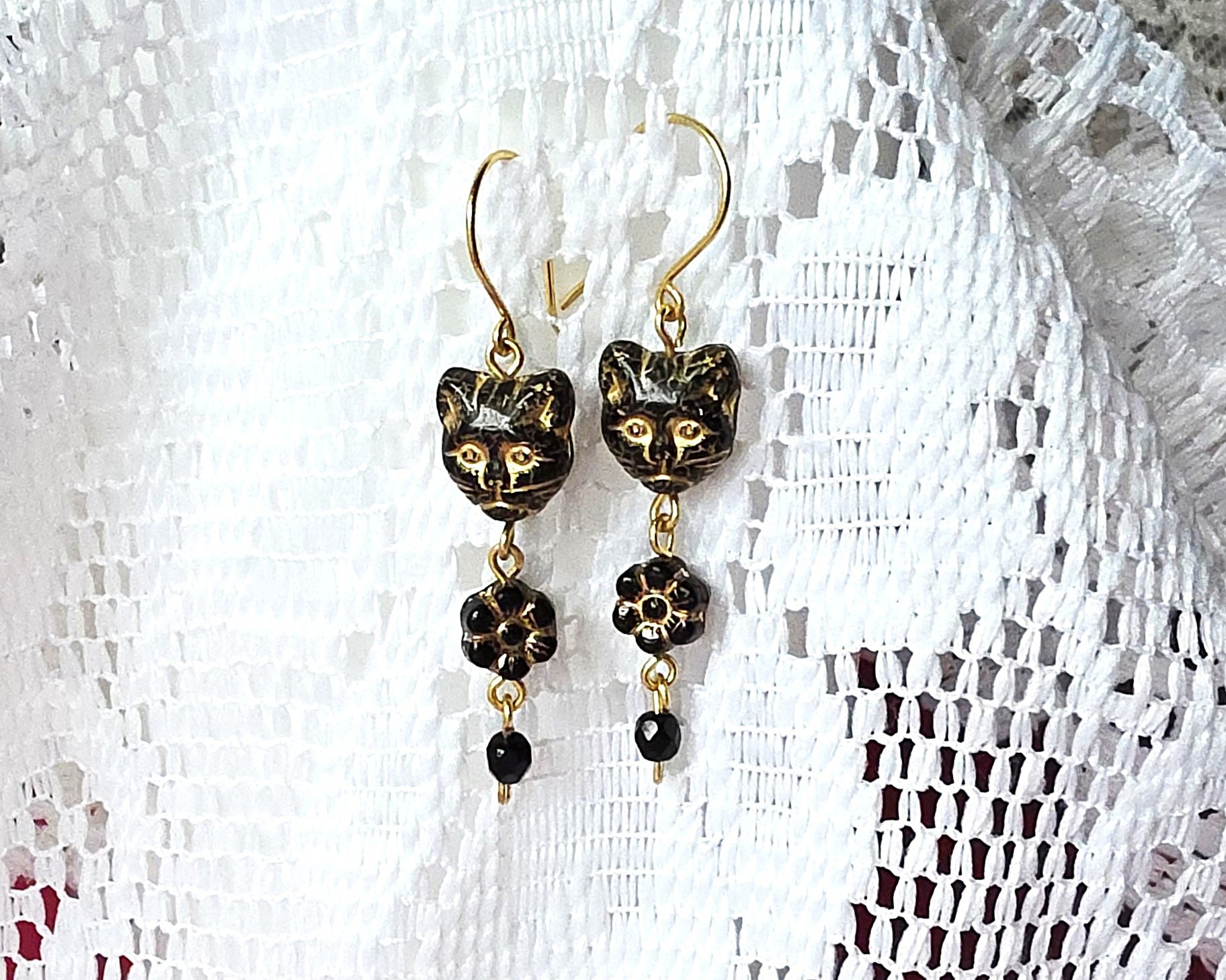 Long Beaded Black Cat Earrings with Gold detail and Brass french hooks on lace background 