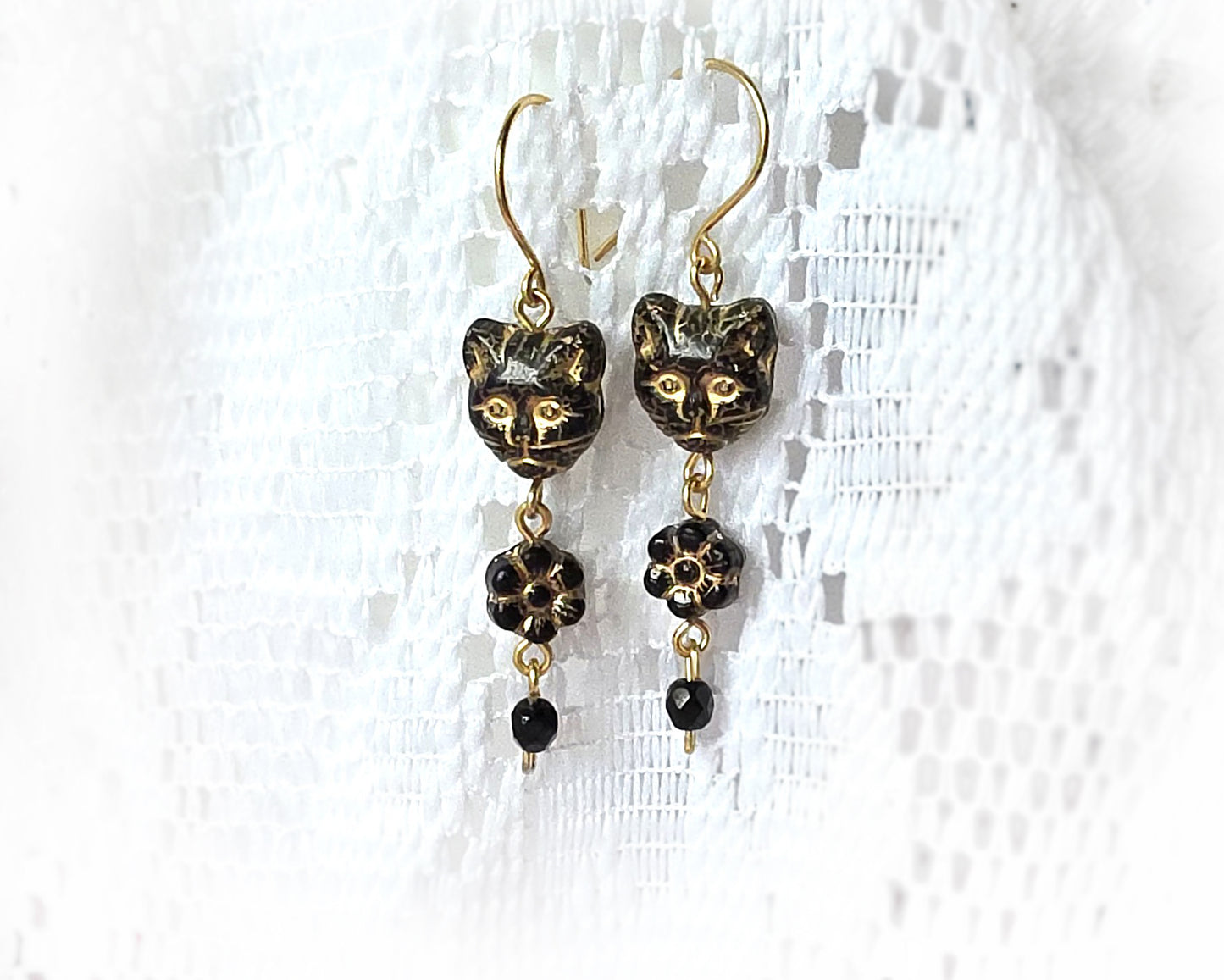 Long Beaded Black Cat Earrings with Gold detail and Brass french hooks on lace background 