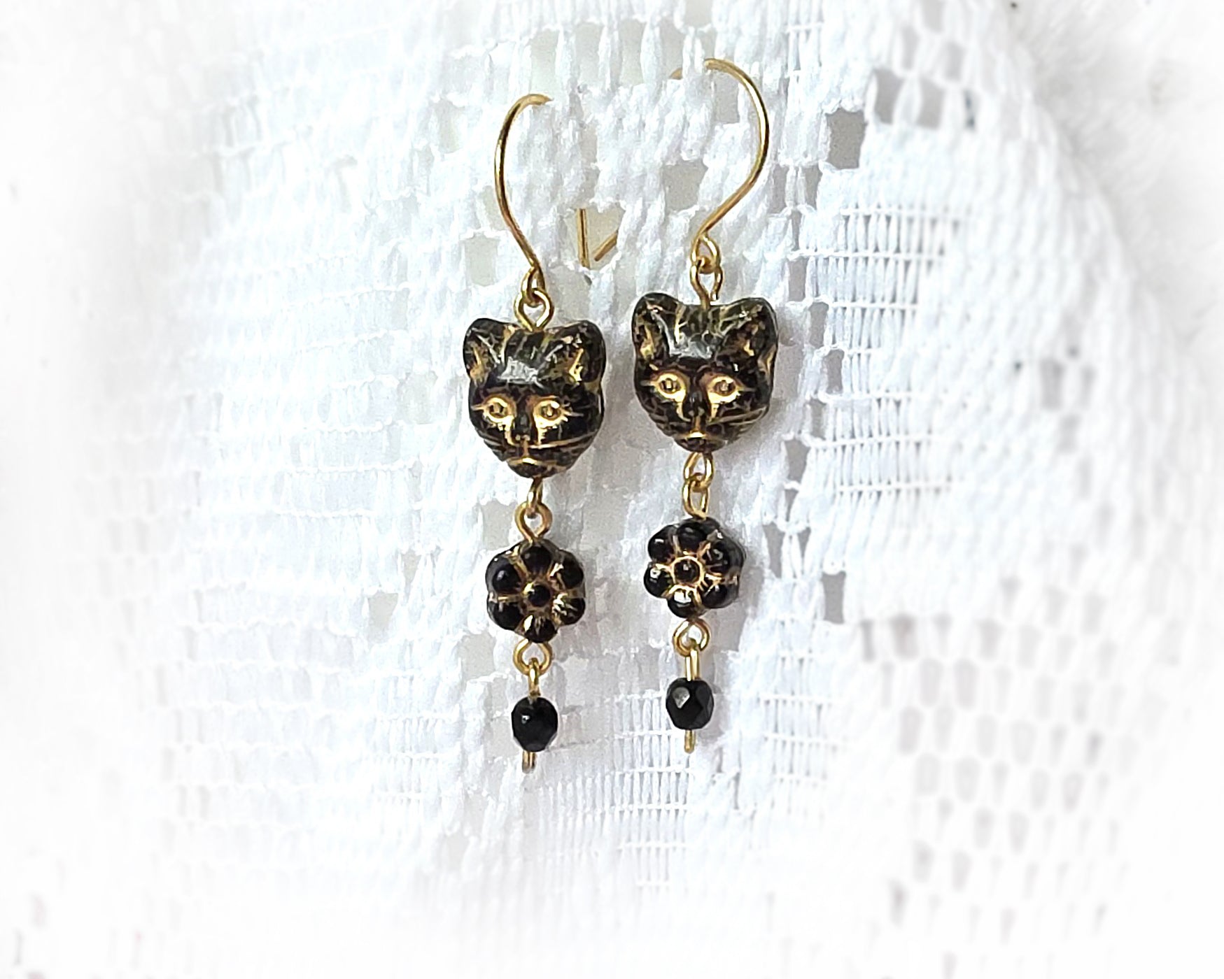 Long Beaded Black Cat Earrings with Gold detail and Brass french hooks on lace background 
