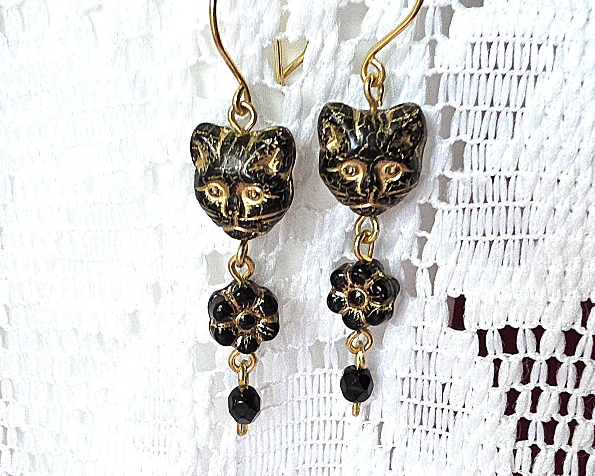 Long Beaded Black Cat Earrings with Gold detail and Brass french hooks on lace background 
