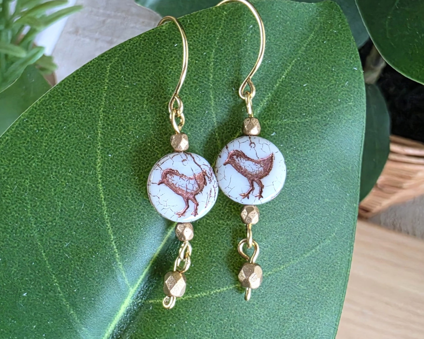 White and gold Sparrow Bird Dangle beaded Earrings on leaf.