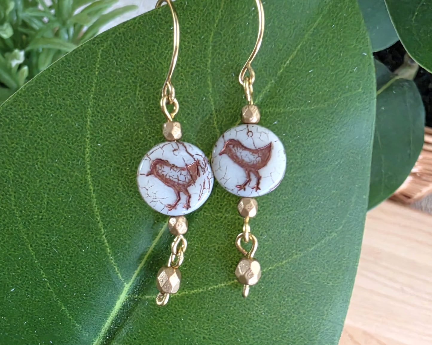 White and gold Sparrow Bird Dangle beaded Earrings on leaf.