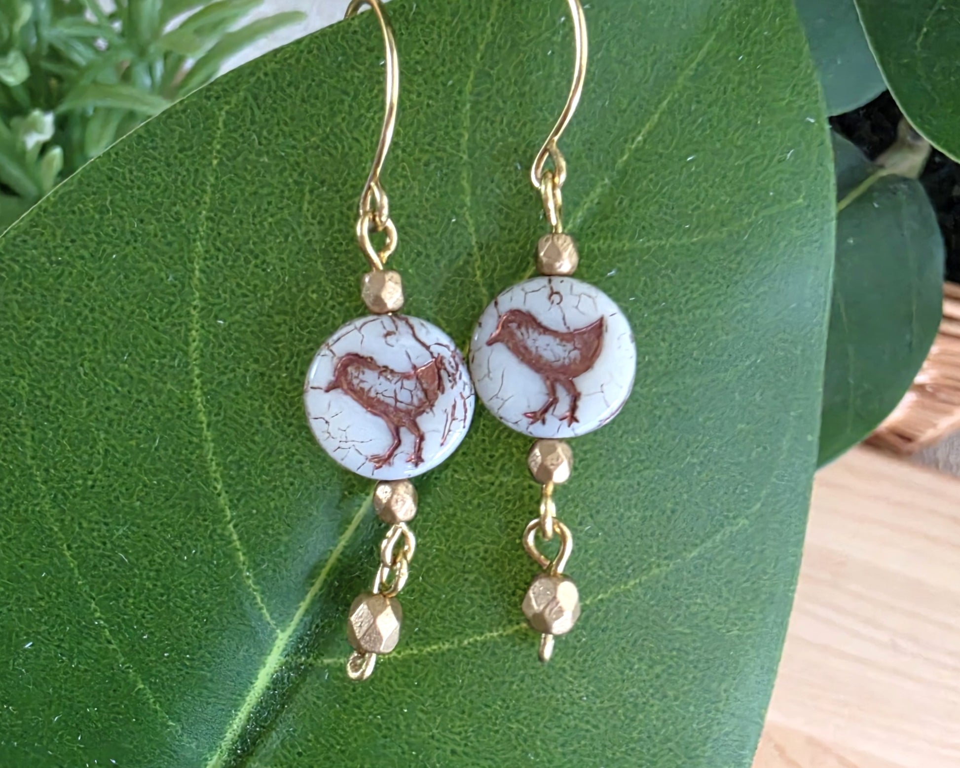 White and gold Sparrow Bird Dangle beaded Earrings on leaf.