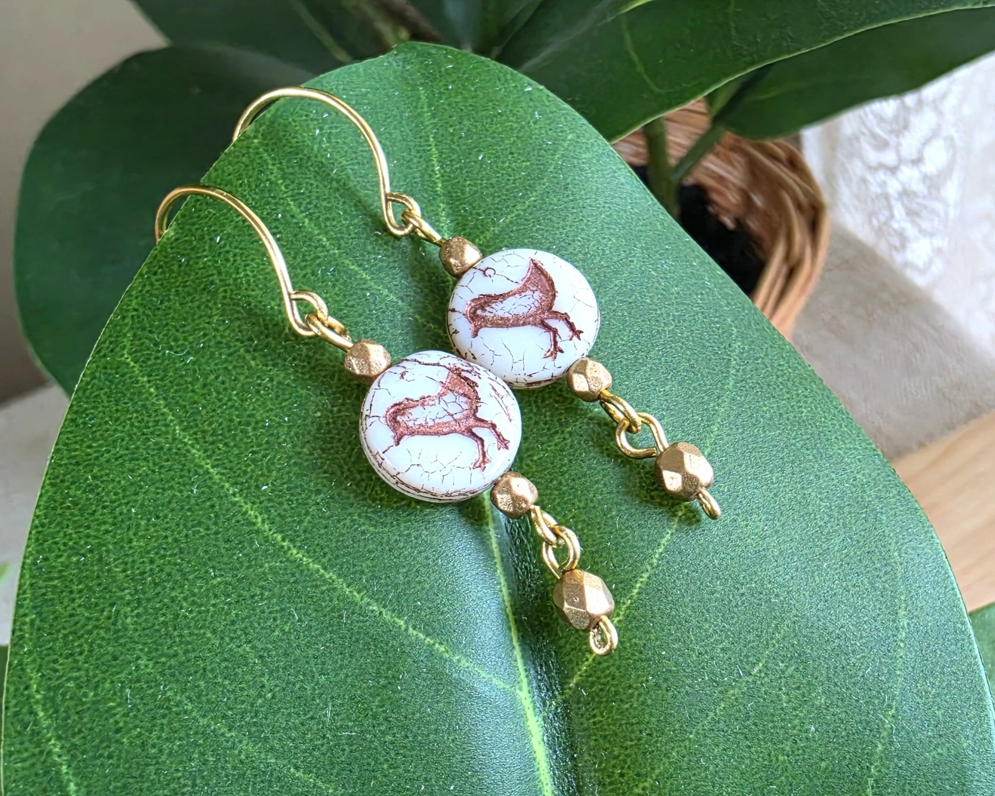 White and gold Sparrow Bird Dangle beaded Earrings on leaf.