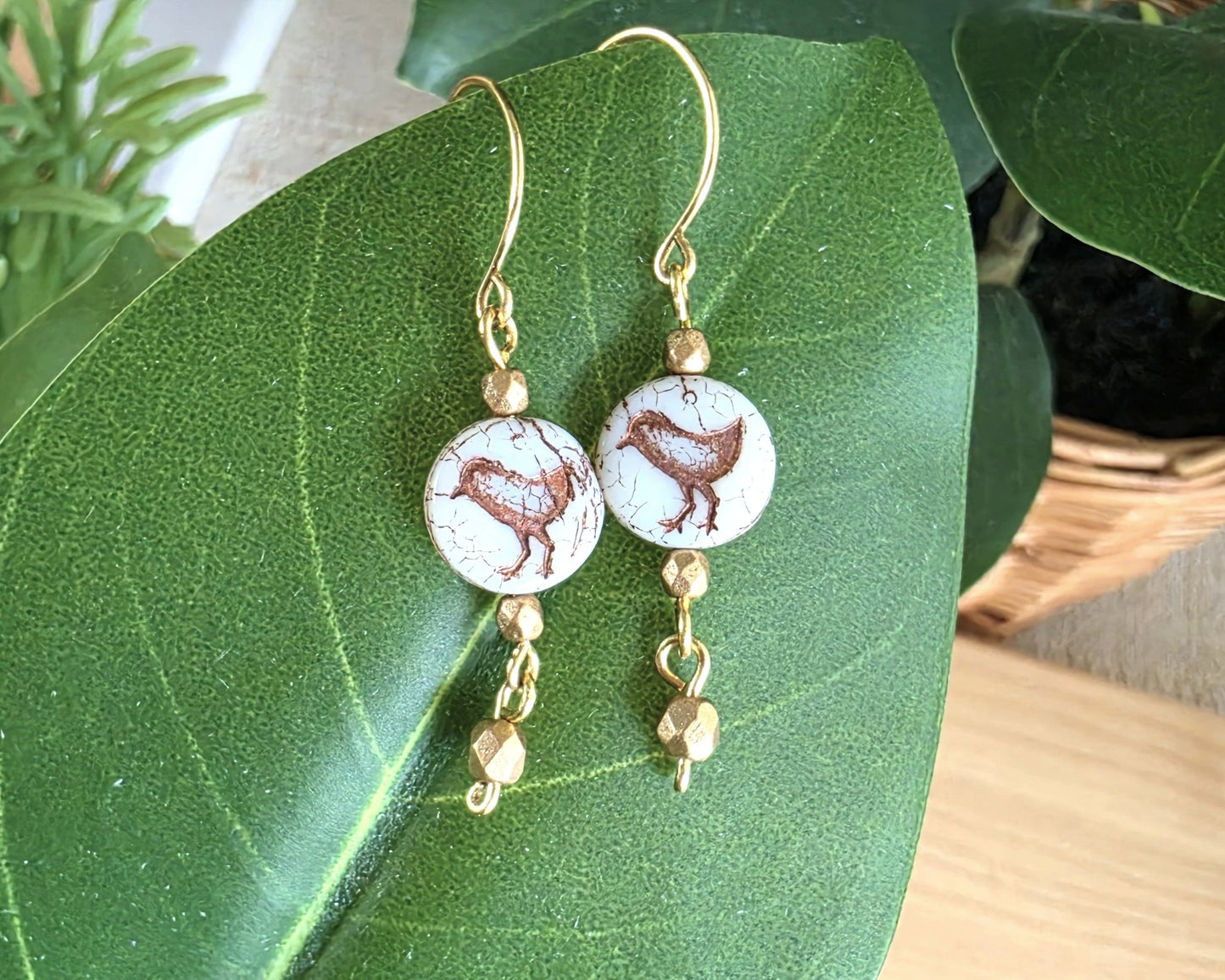 White and gold Sparrow Bird Dangle beaded Earrings on leaf.
