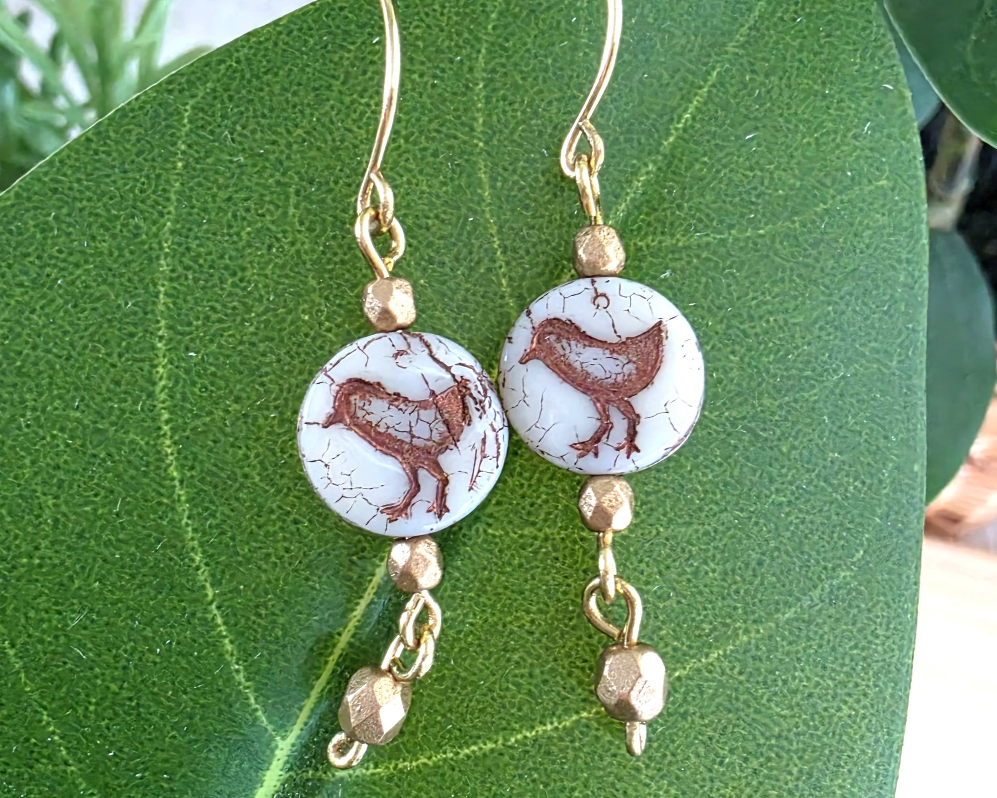 White and gold Sparrow Bird Dangle beaded Earrings on leaf.