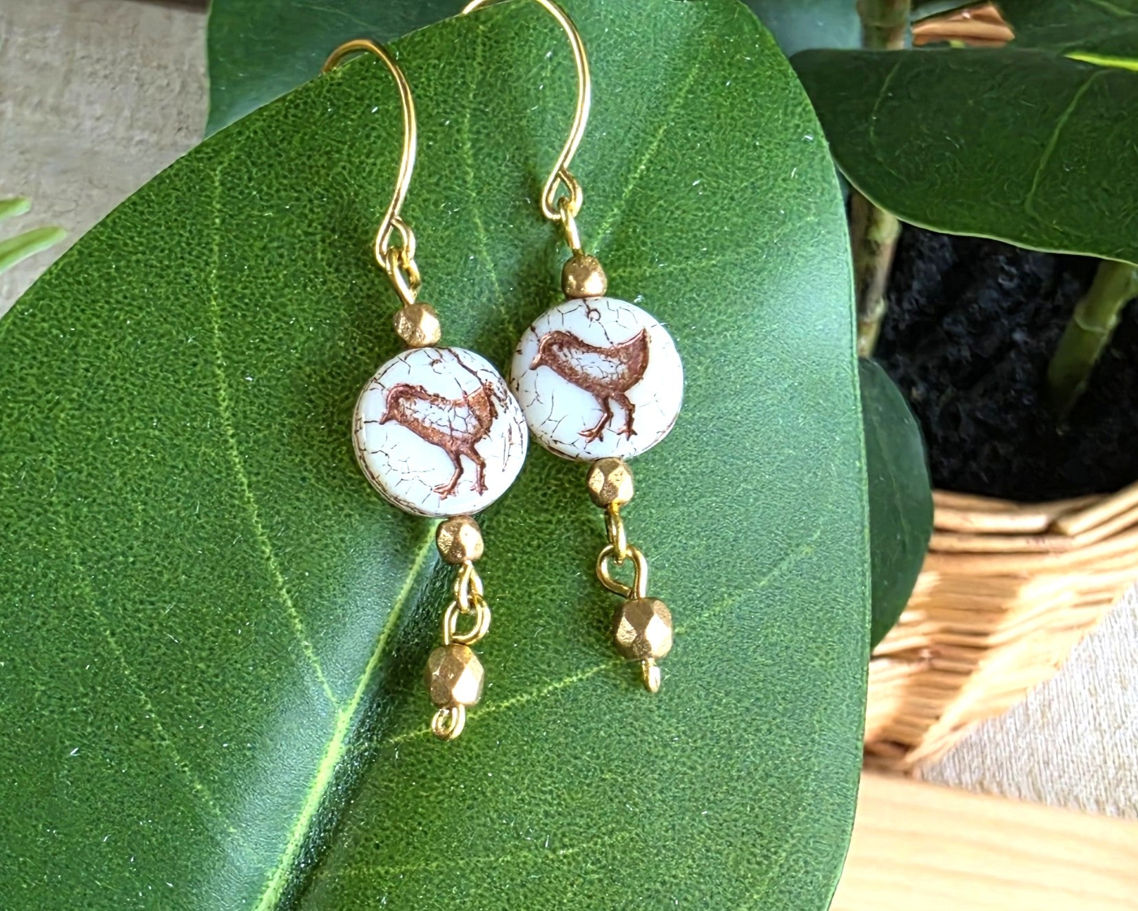 White and gold Sparrow Bird Dangle beaded Earrings on leaf.