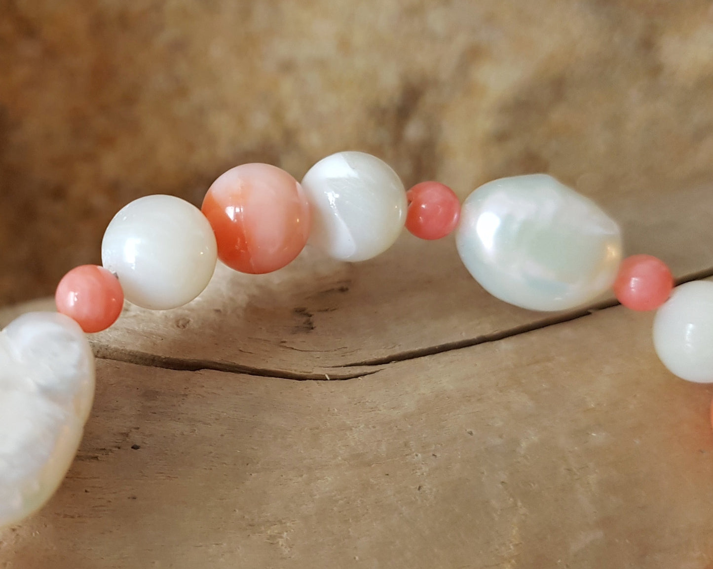 Angle Skin Coral, Mother of Pearl, Freshwater Cultured Pearl Beaded Bracelet. Pale orange Coral, white Mother of Pearl, white Pearls.