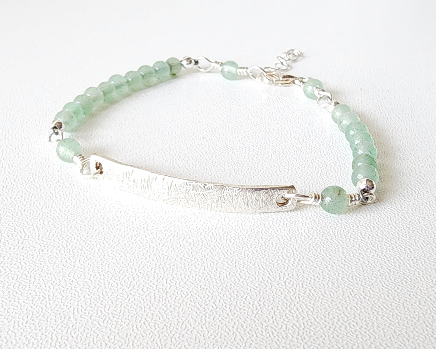 Eco Sterling Silver Aventurine Peace Bridge Bracelet with textured rectangular bar and 4mm round polished soft green Aventurine stone beads. 
