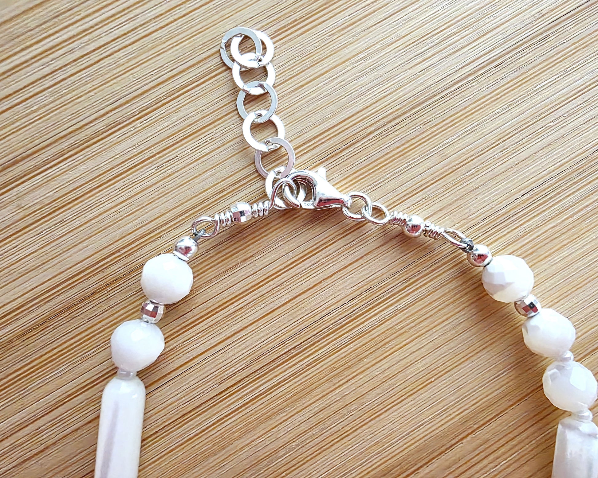 Mother of Pearl PEACE bracelet, Morse Code spells PEACE with round faceted beads and long antique beads with 925 Sterling Silver on wood. 