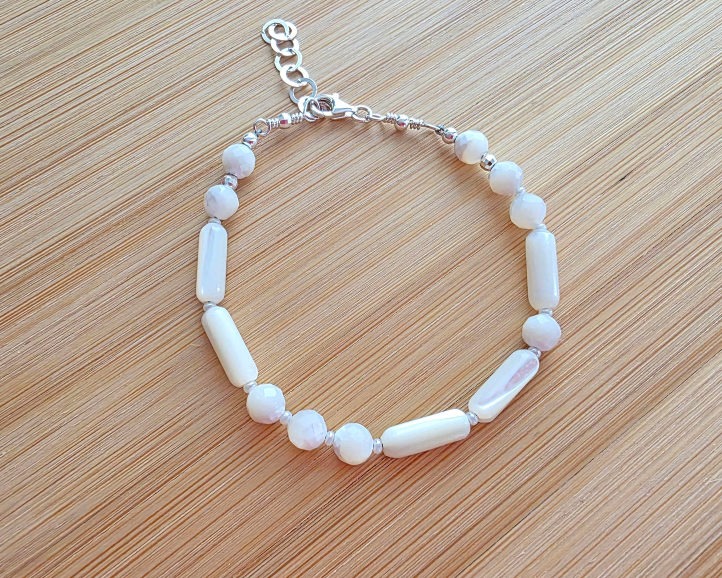 Mother of Pearl PEACE bracelet, Morse Code spells PEACE with round faceted beads and long antique beads with 925 Sterling Silver on wood. 