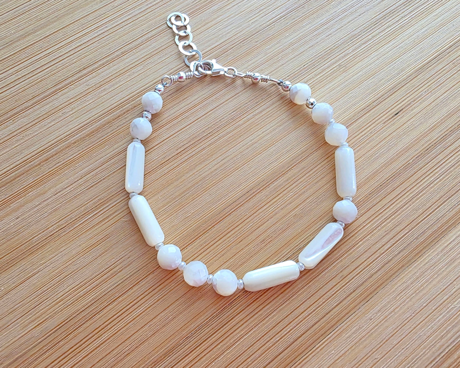 Mother of Pearl PEACE bracelet, Morse Code spells PEACE with round faceted beads and long antique beads with 925 Sterling Silver on wood. 