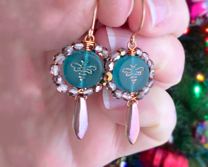 A pair of handmade turquoise aqua blue glass bee earrings with gold detail, gold and copper beads and wire on french earrings hooks