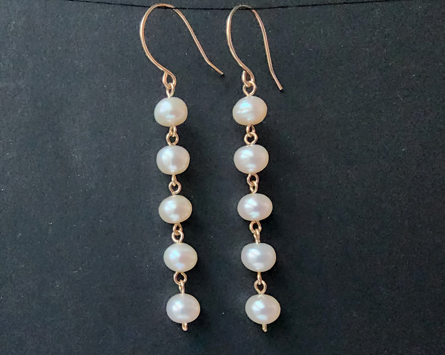 Long white pearl Dangle earrings with five round  Freshwater Cultured Pearls and 14k gold filled metal, dangling from French style earring wires. 