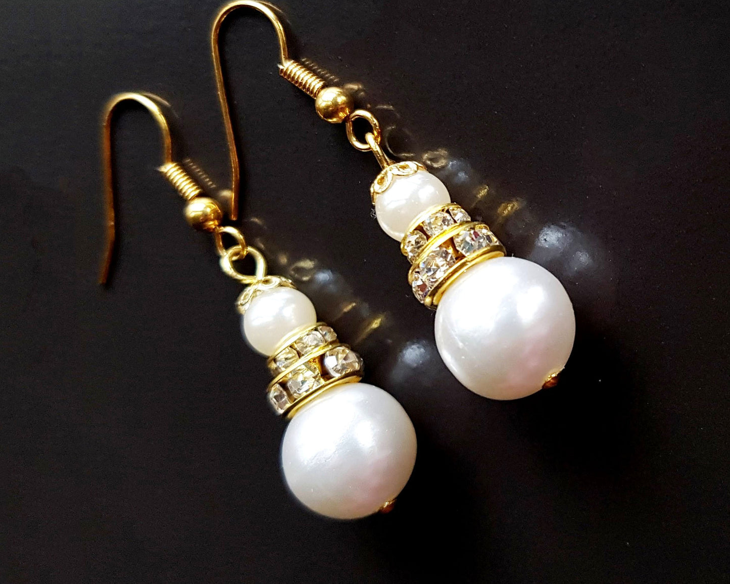 Victorian Style Large Pearl and Crystal Earrings, long dangles earring with large white peals and decorative gold details and crystal. Earrings dangle on french style earring hooks 