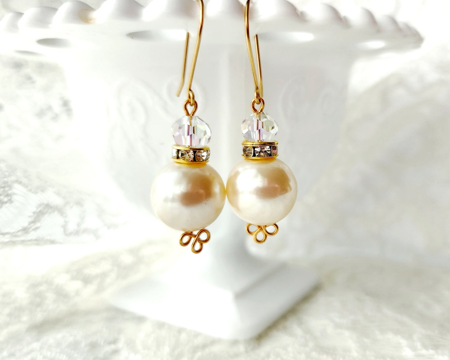 Vintage Pearl Crystal Celtic Earrings, Large cream color pearls with sparkly clear faceted crystal and Celtic Trinity knot design on the base of the pearls. Long French style earring wires. 