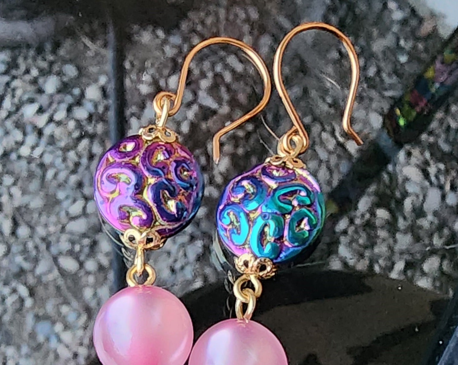 Long Pink Moonglow Star Earrings with titanium electroplated Hematite Stars, pink Moonglow 1960’s Lucite beads and metallic blue, purple and gold Czech Glass beads, all one Brass wire and French earring hooks. 