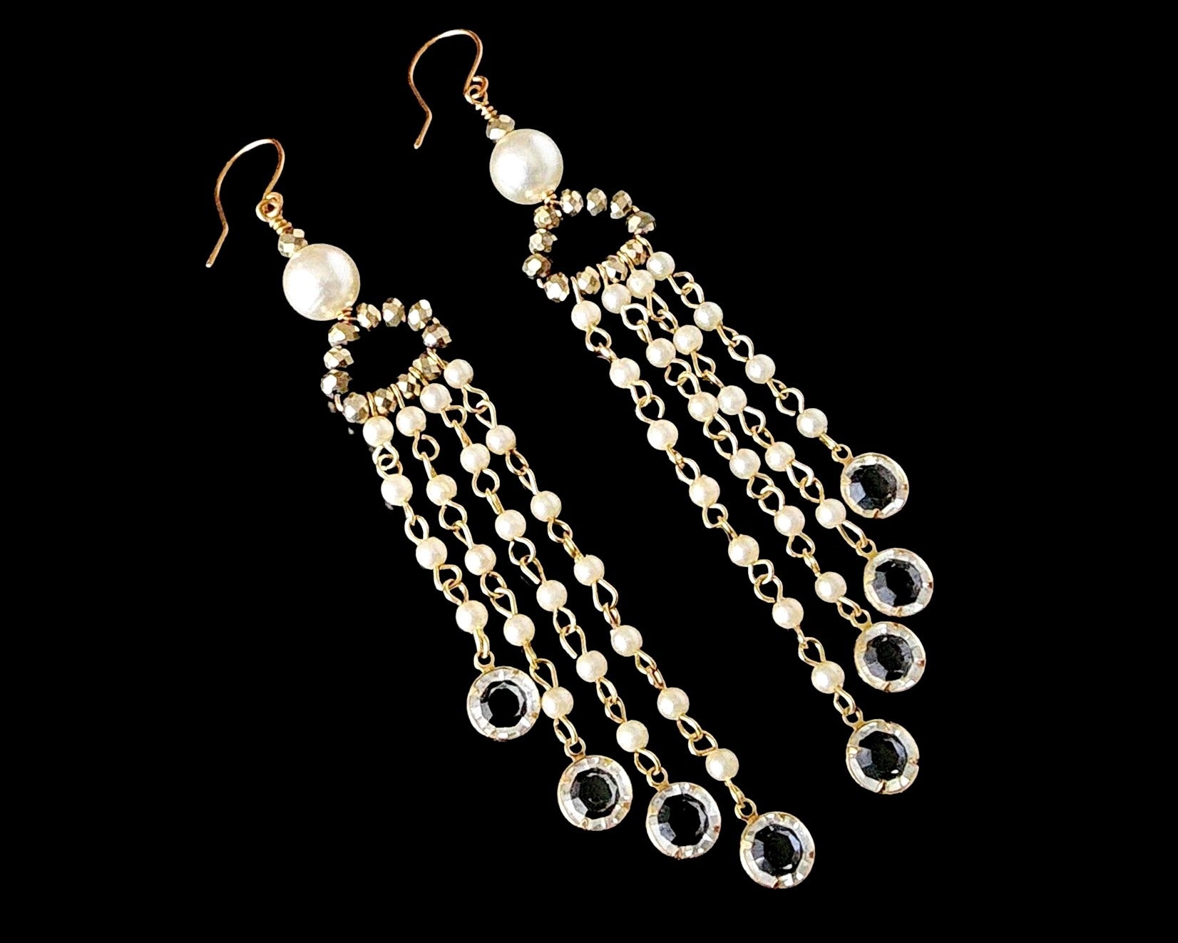 Long Eco Elegance Pearl Crystal Chandelier Tassel Earrings with long streams of tiny white pears and crystal pendants on the base of each strand, dangling from gold crystal and large white pearls. 