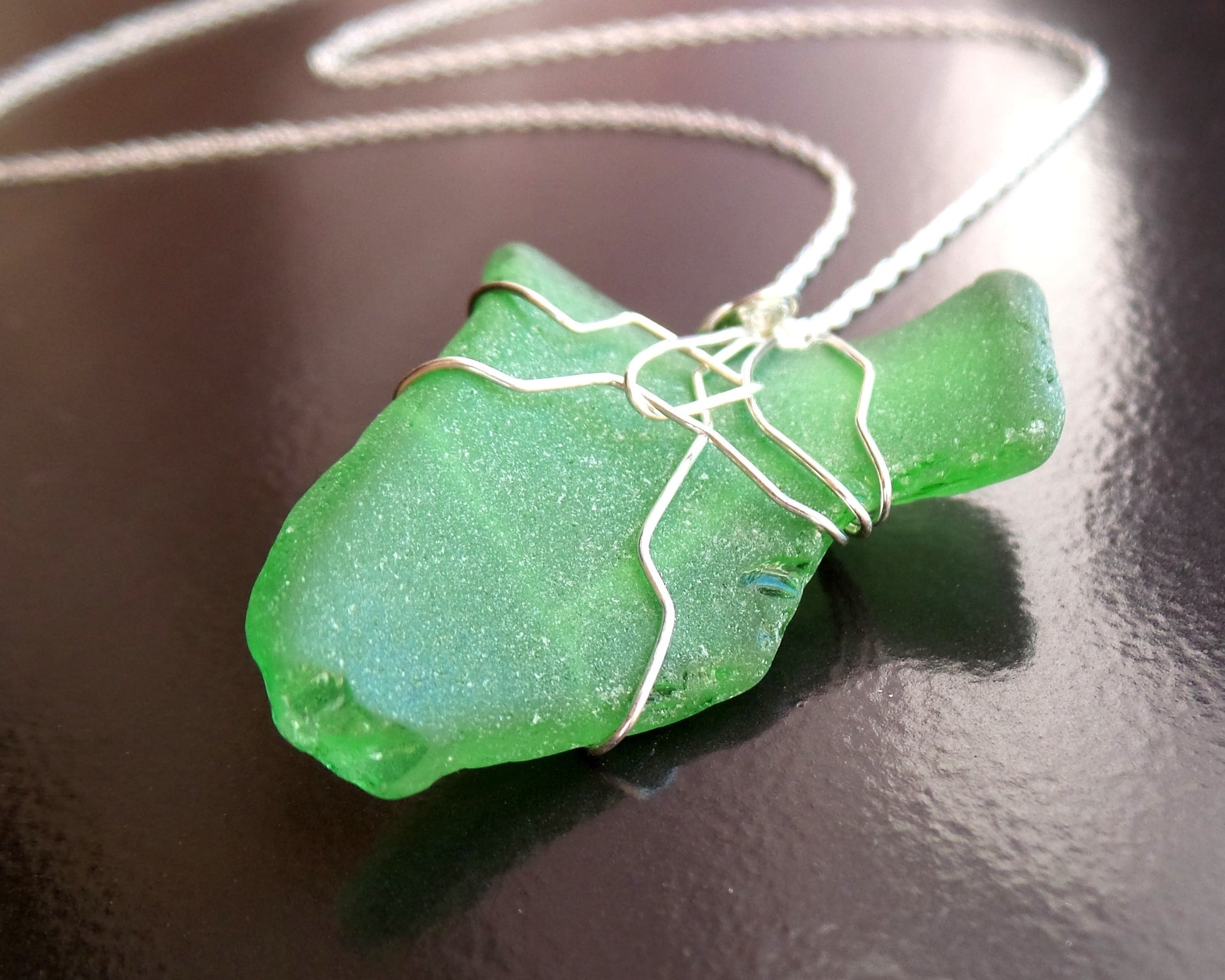Green Leaf Freshwater Sea Glass / Beach Glass Pendant wire wrapped, dangling on Sterling Silver chain on black background